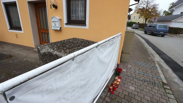 Kerzen und Blumen stehen vor dem Haus in Weilheim., © Karl-Josef Hildenbrand/dpa